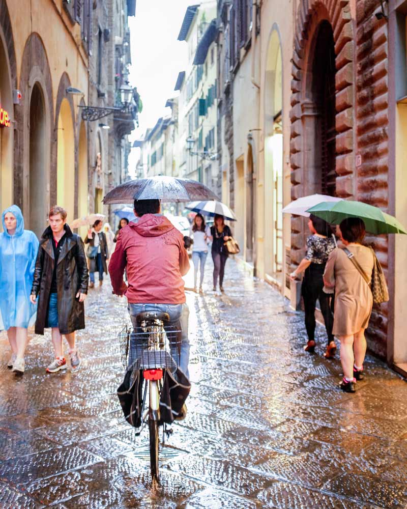 Cyclist umbrella Florence Italy