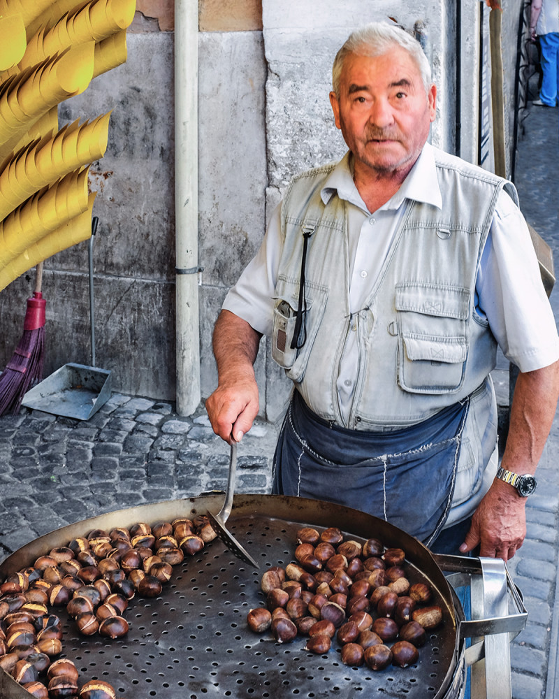 Man roasting chestnuts Rome Italy