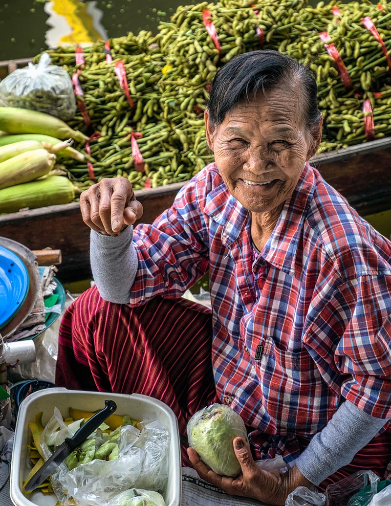 Damnoen Saduak floating market woman smiling Bangkok Thailand